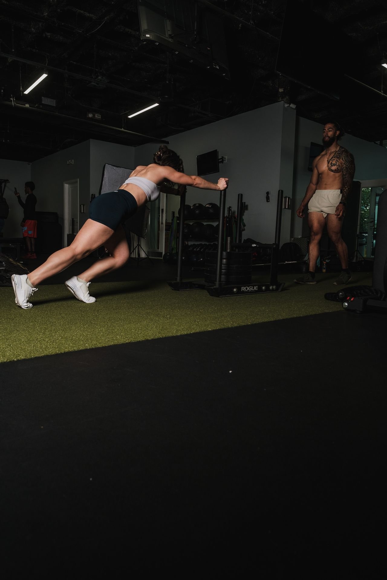 Athlete pushing a weighted sled at FORGE