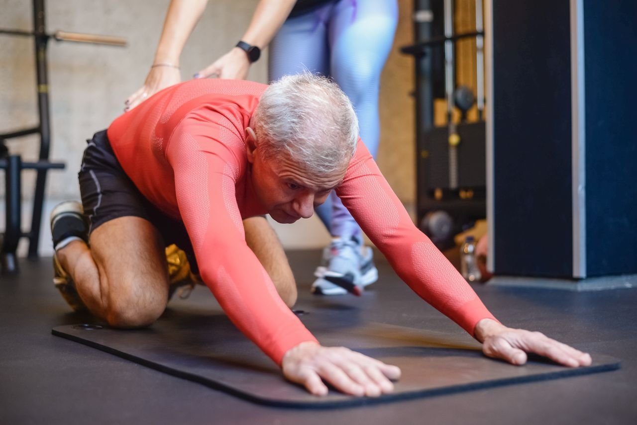 Coach assessing an athlete on the training floor
