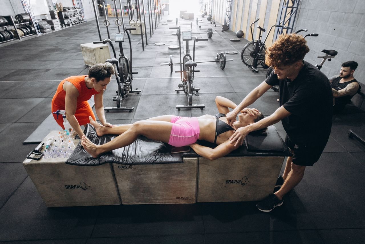 Coach helping an athlete recover after training